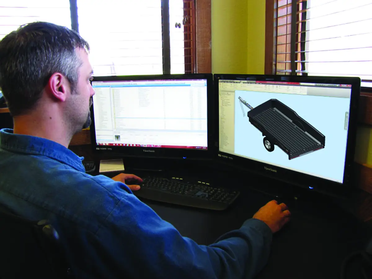 Floe Thermoforming engineer reviewing part geometry and tooling on a CAD workstation